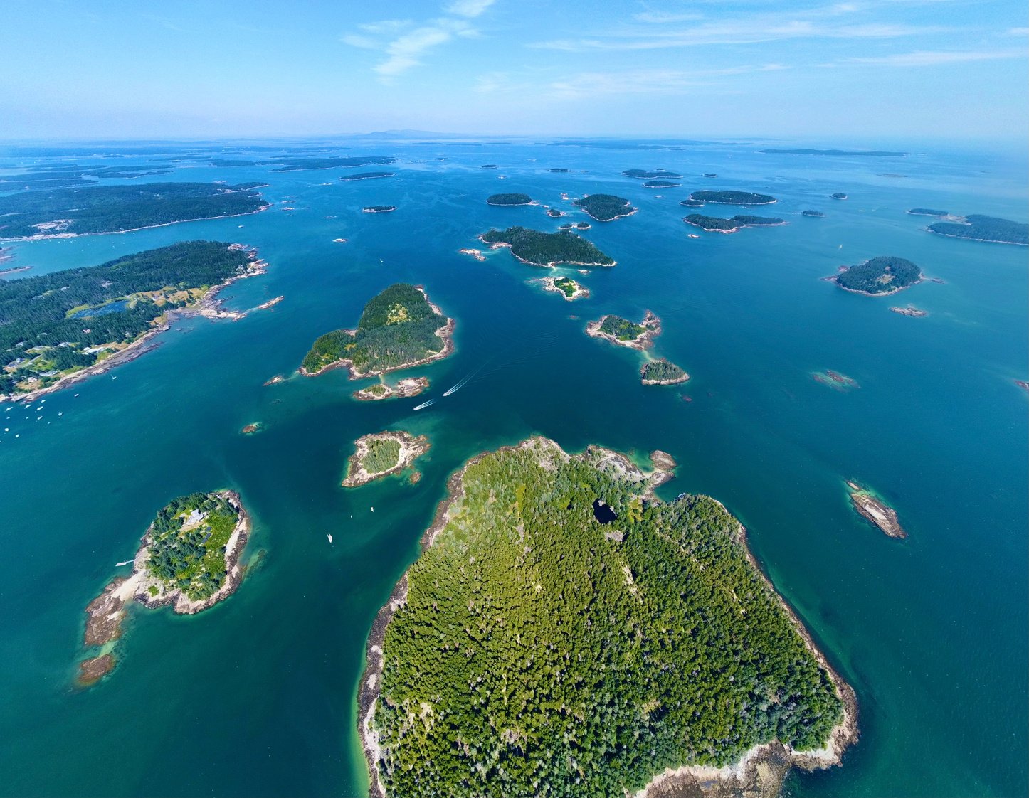 Arial view of Penobscot Bay islands off of Stonington Maine. Ocean and trees and water.